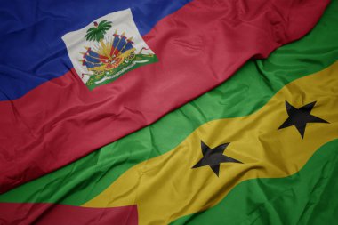 waving colorful flag of sao tome and principe and national flag of haiti. macro.3d illustration