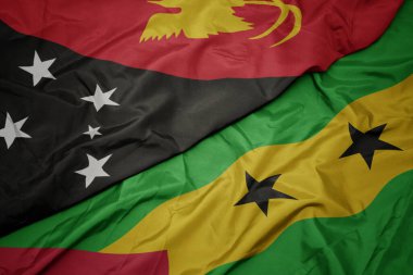 waving colorful flag of sao tome and principe and national flag of Papua New Guinea . macro.3d illustration