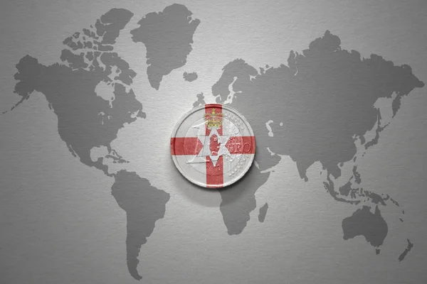 euro coin with national flag of northern ireland on the gray world map background.3d illustration. finance concept