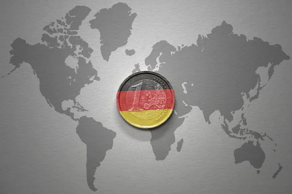 灰色の世界地図の背景にドイツの国旗を持つユーロコイン 金融の概念 — ストック写真