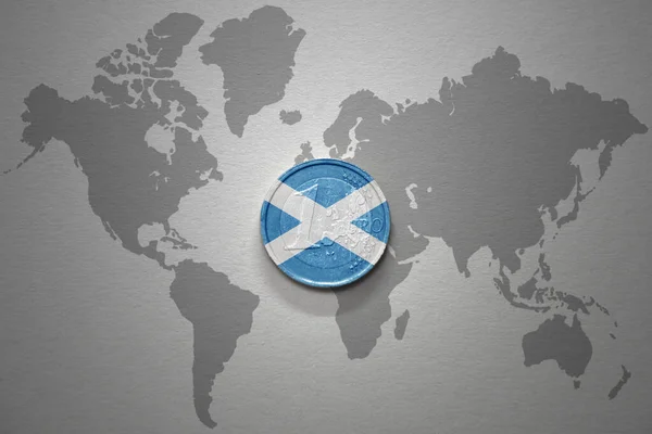 euro coin with national flag of scotland on the gray world map background.3d illustration. finance concept