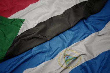 Sudan 'ın renkli bayrağı ve Nikaragua' nın ulusal bayrağı sallanıyor. Makro. 3d illüstrasyon