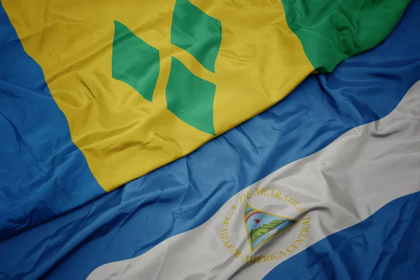 Mávající Barevnou Vlajkou Svatého Vincenta Granáty Národní Vlajkou Nikaraguy Makro — Stock fotografie