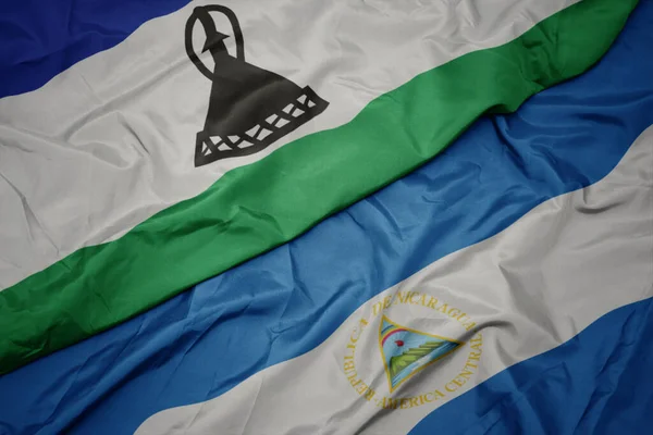 Machając Barwną Flagą Lesotho Narodową Flagą Nikaragui Makro Ilustracja — Zdjęcie stockowe