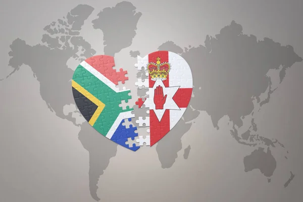 puzzle heart with the national flag of south africa and northern ireland on a world map background.Concept. 3D illustration