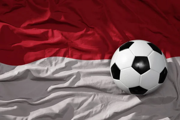 インドネシアの国旗の上にある古くからのヴィンテージサッカーボールです 3Dイラスト — ストック写真