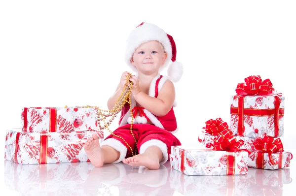Malý chlapec santa claus s vánoční dárky na bílé poza — Stock fotografie