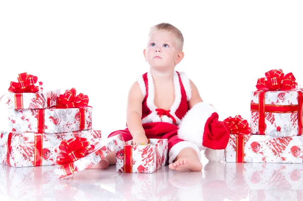 Petit garçon Père Noël avec des cadeaux de Noël sur fond blanc — Photo