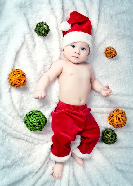 Adorable little baby Santa Claus with Christmas balls — Stock Photo, Image