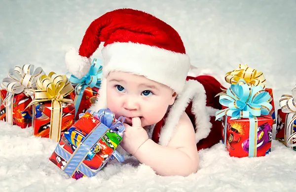 Cute little santa baby with New years gifts — Stock Photo, Image