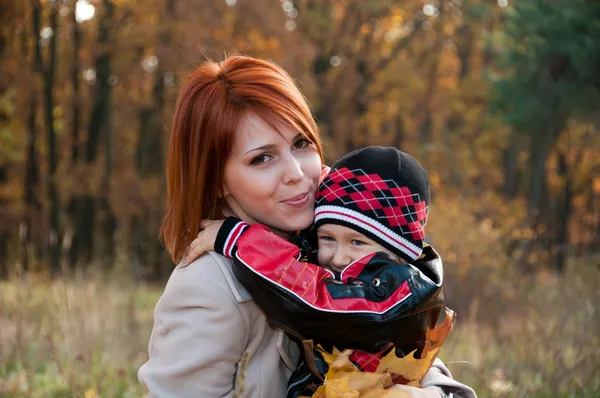 Família feliz, mãe e filho na floresta de outono — Fotografia de Stock