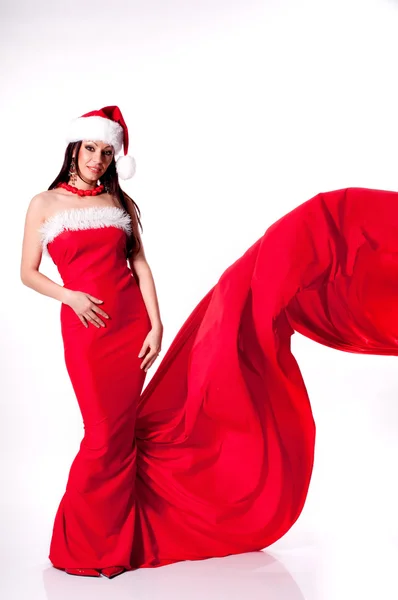 Menina morena muito de cabelos longos em um vestido vermelho longo como Papai Noel — Fotografia de Stock