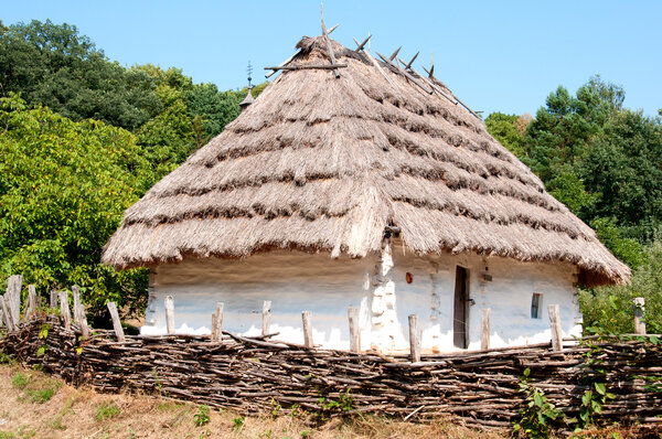 Traditional Ukrainian house with a thatched roof.