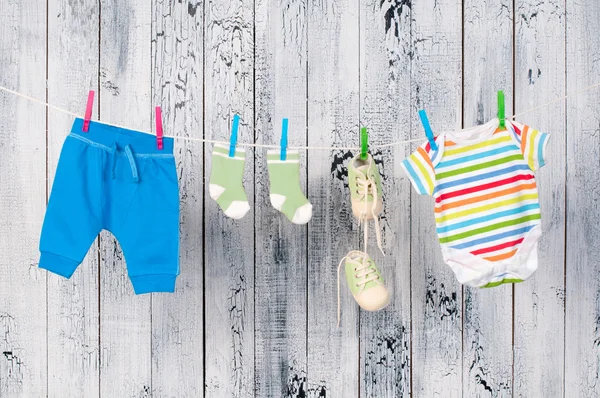 Babykläder hänger på klädstreck. — Stockfoto