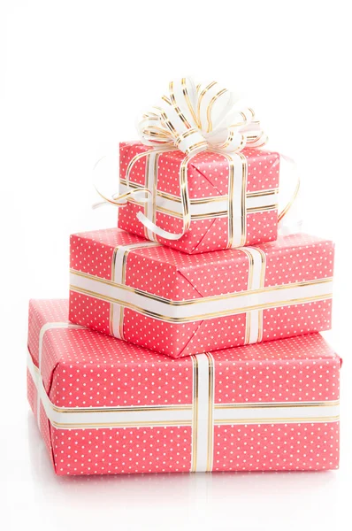 Wrapped gifts with a bow on a white background. — Stock Photo, Image