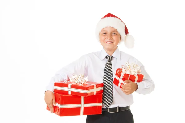Счастливый мальчик в рождественской шляпе с подарками . — стоковое фото