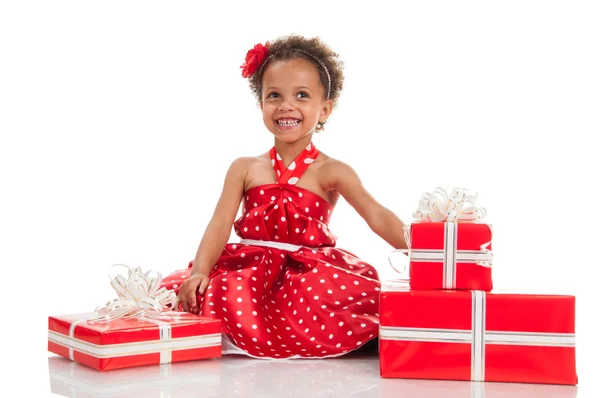Little surprised mulatto girl with gifts. — Stock Photo, Image
