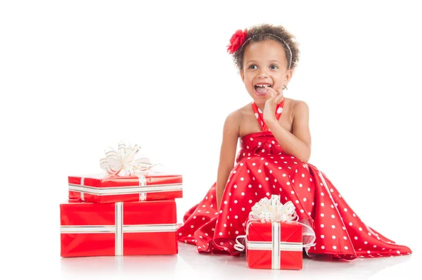 Happy little girl with a gift in mulatta hands. — Stock Photo, Image