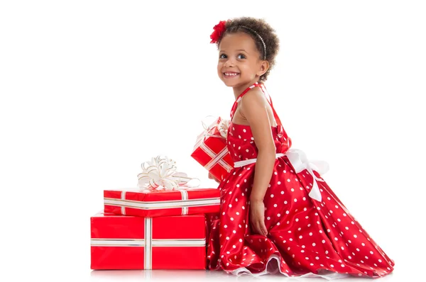 Happy little girl with a gift in mulatta hands. — Stock Photo, Image