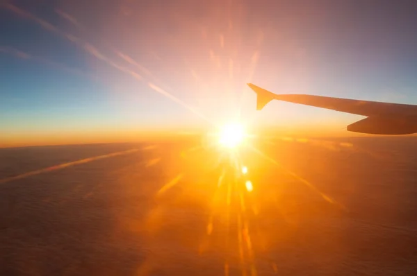 View from the plane on a beautiful orange sunset — Stock Photo, Image