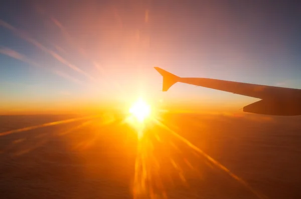 View from the plane on a beautiful orange sunset — Stock Photo, Image