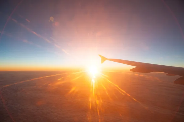 View from the plane on a beautiful orange sunset — Stock Photo, Image