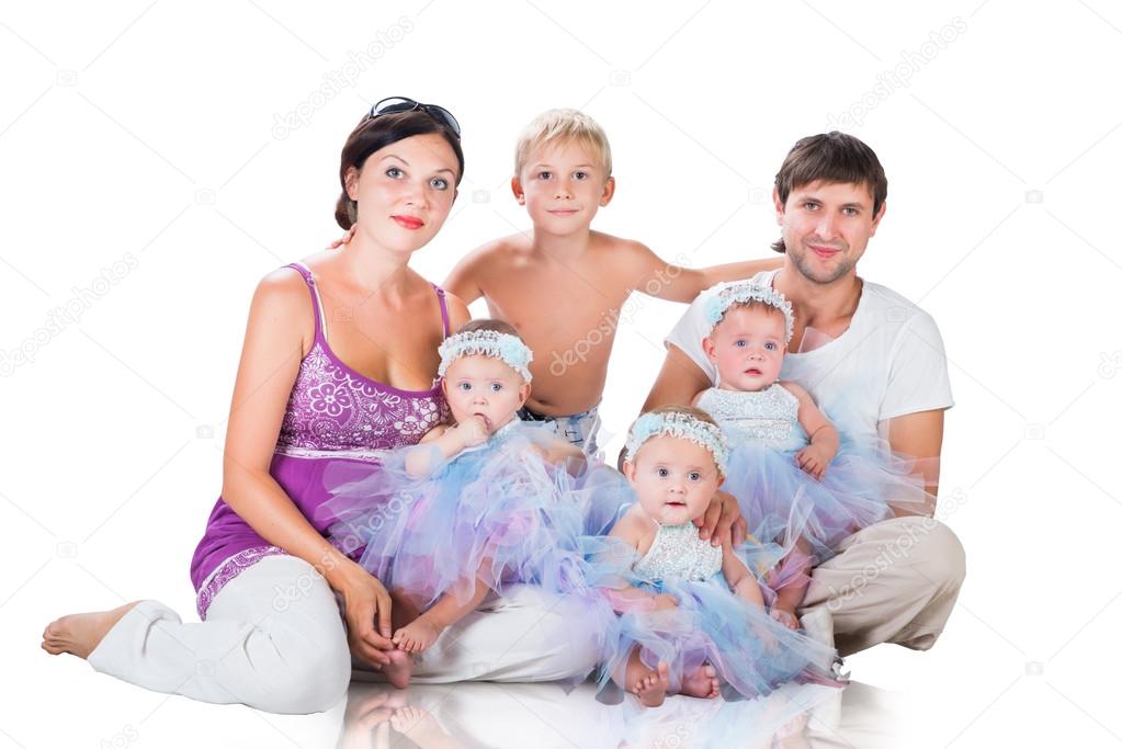 Big happy family: mother, father, triplets daughter and son