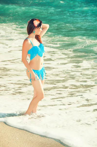 Hermosa joven en un traje de baño en la playa — Foto de Stock