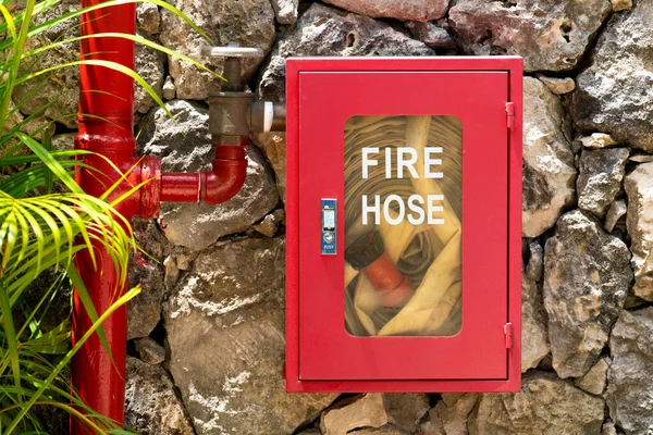 Red Fire Hose Hangs Stone Wall Exotic Hotel Fire Extinguishers — Stock Photo, Image