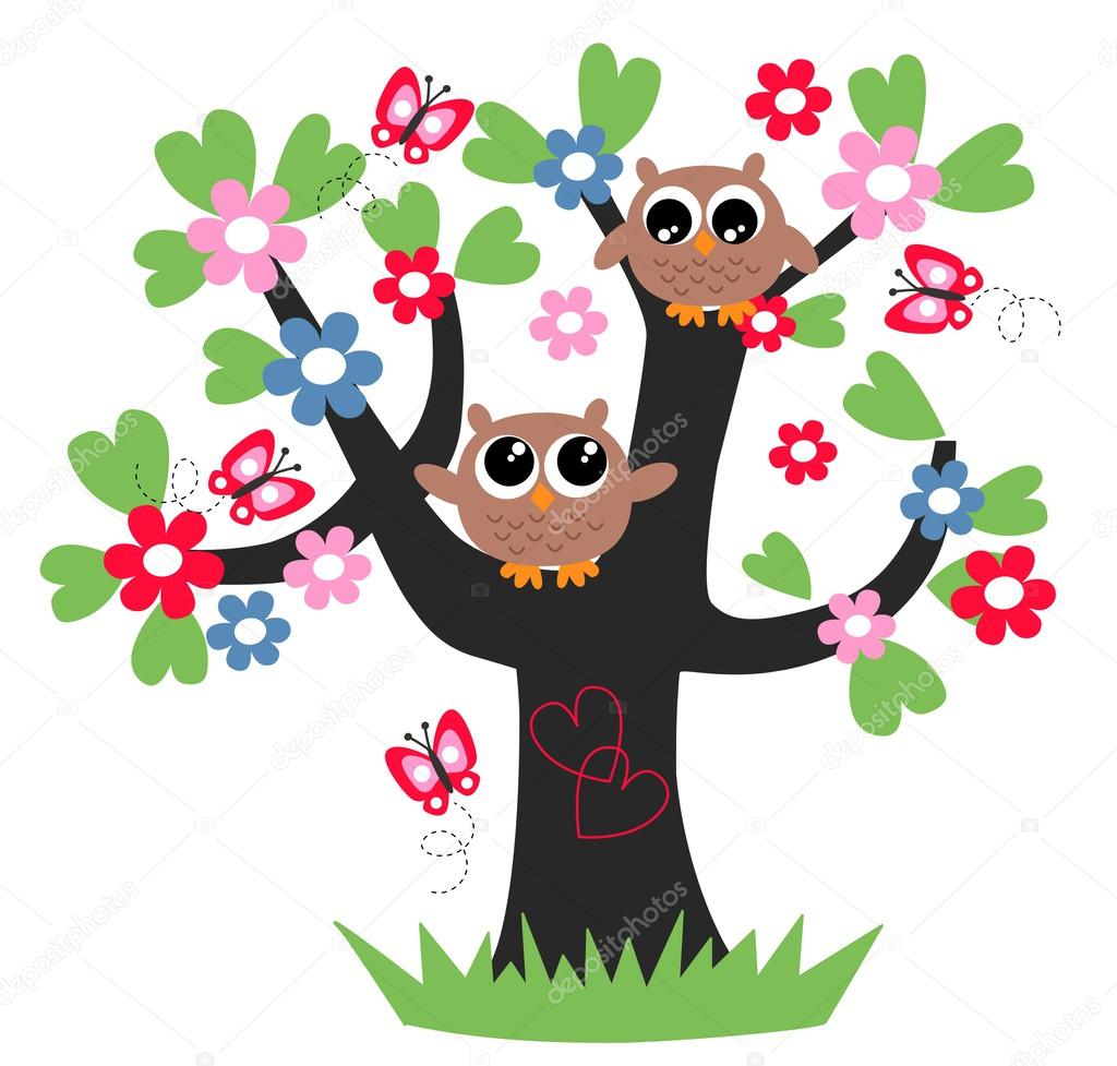 Two sweet owls sitting in a tree