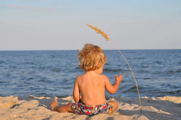 Un enfant à la plage avec des épillets — Photo