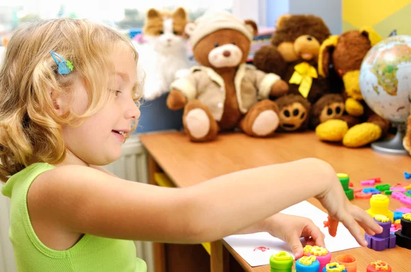 Little girl painting hands in her room. — Stock Photo, Image