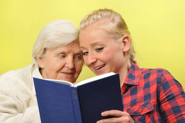 Senior woman with her caregiver in home. — Stock Photo, Image