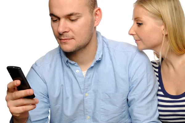 Unga kvinnan ser på sin makes telefon. — Stockfoto