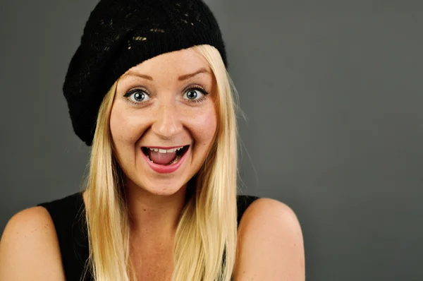 Young blonde happy woman on grey wall. — Stock Photo, Image