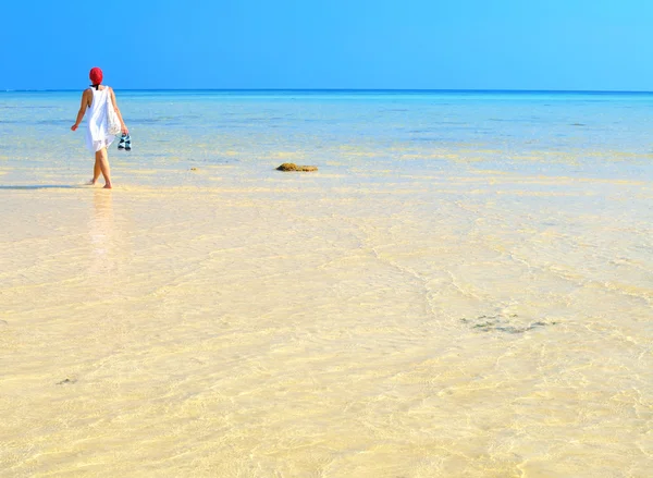 Kvinna promenader på stranden — Stockfoto