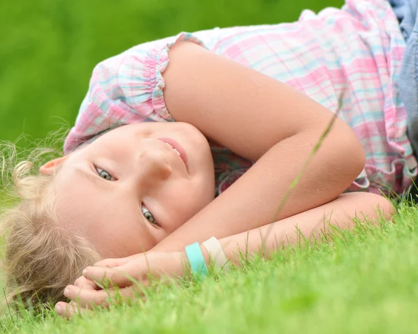 Junges Mädchen liegt auf dem Gras. — Stockfoto