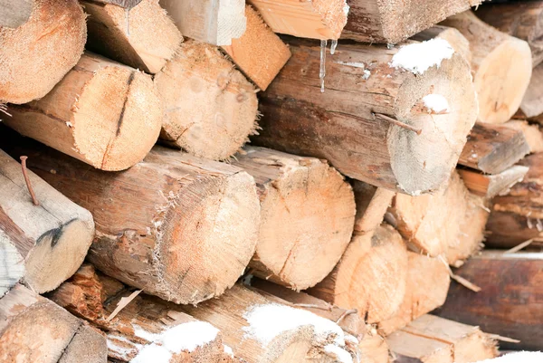 Firewood stacked in a pile in the winter — Stock Photo, Image