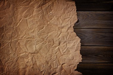 Old scorched paper on the wooden texture clipart