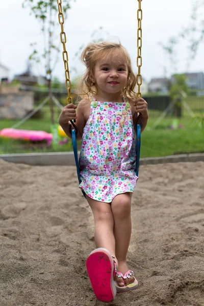 Little Girl Swinging after a Meal — Stock Photo, Image