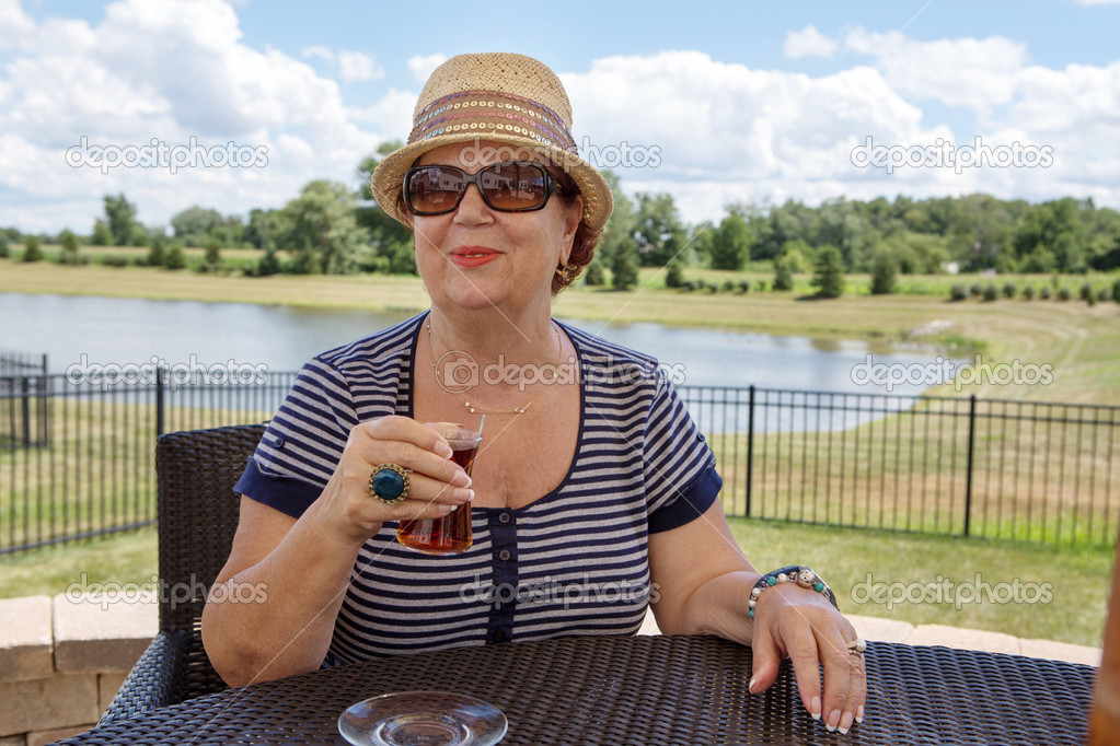 Senior woman enjoying a drink outdoors