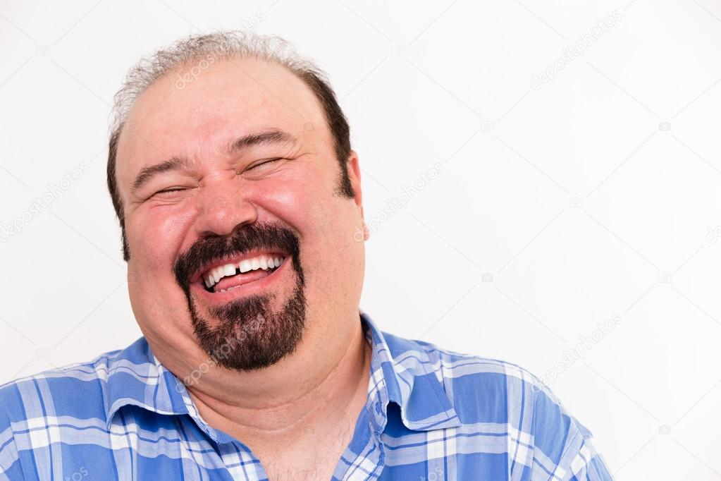 Cheerful middle-aged Caucasian man laughing loud