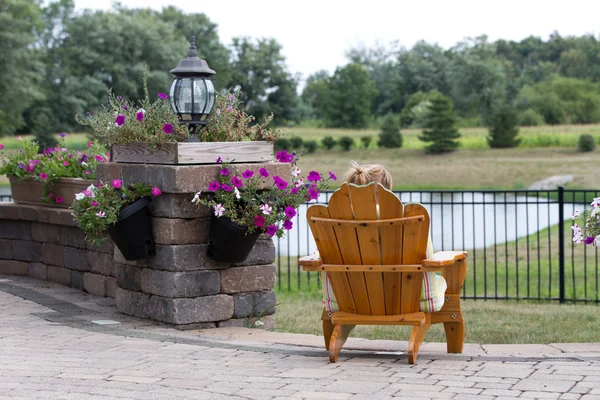 Person relaxing in a garden chair — Stock Photo, Image