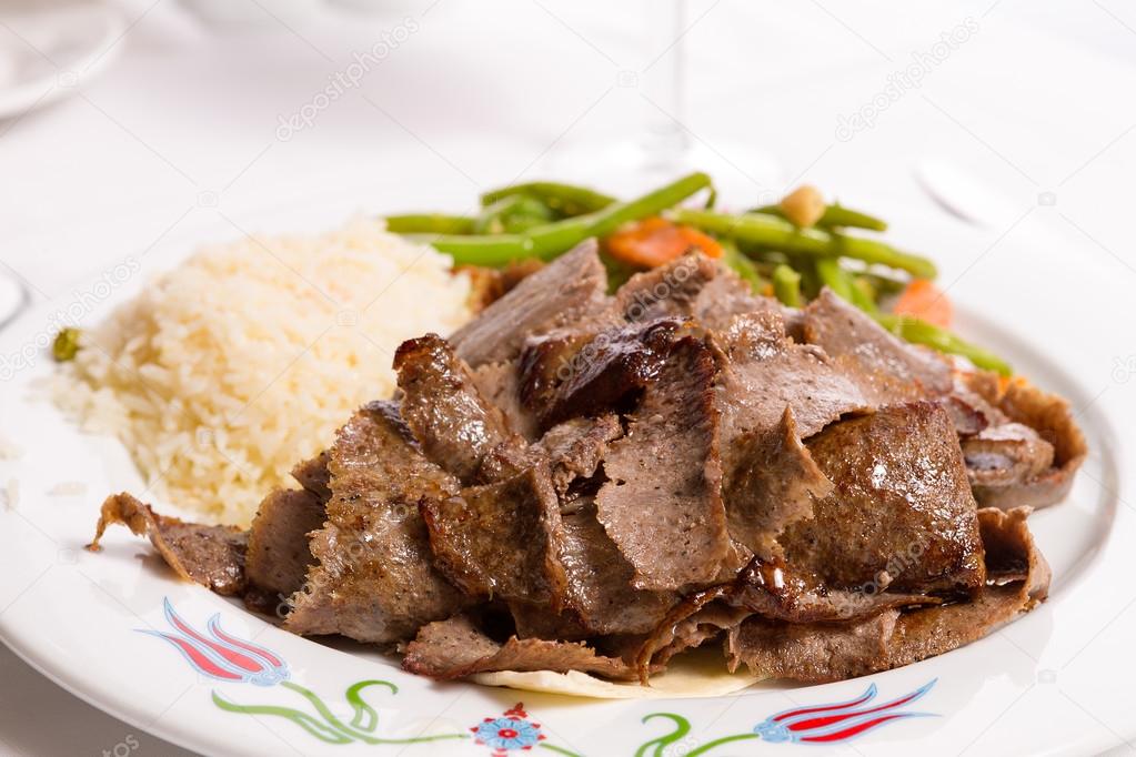 Gyro Doner Garnished with Rice Pilaf and Vegetables served on th
