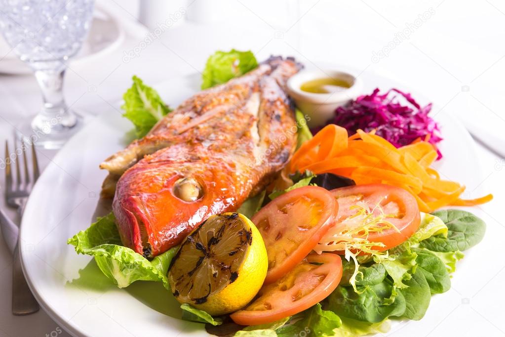 Full Cooked Tilapia Served with Vegetables and Fish Sauce Compli
