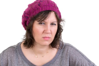 Woman frowning in disbelief with an assessing look clipart