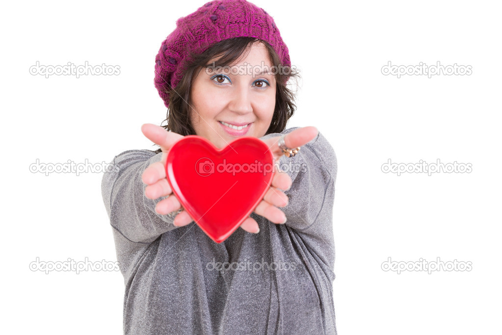 Happy woman holding out a red valentines heart