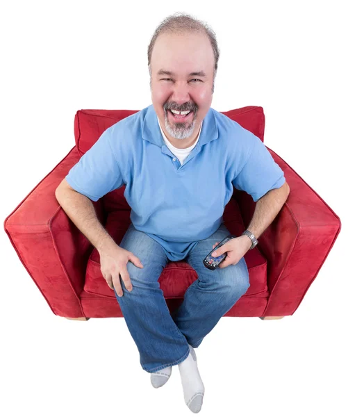 Man laughing as he watches television — Stock Photo, Image