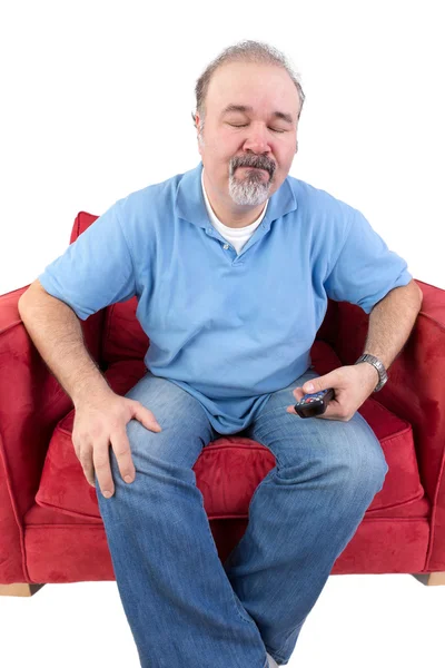 Man with a remote closing his eyes in resignation — Stock Photo, Image