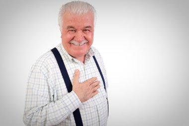 Sincere senior man with his hand on his heart clipart